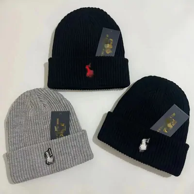 Three ribbed beanies in grey, black and navy with paper tags attached
