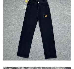 Dark navy straight-leg jeans with a yellow tag hanging against a plain wall